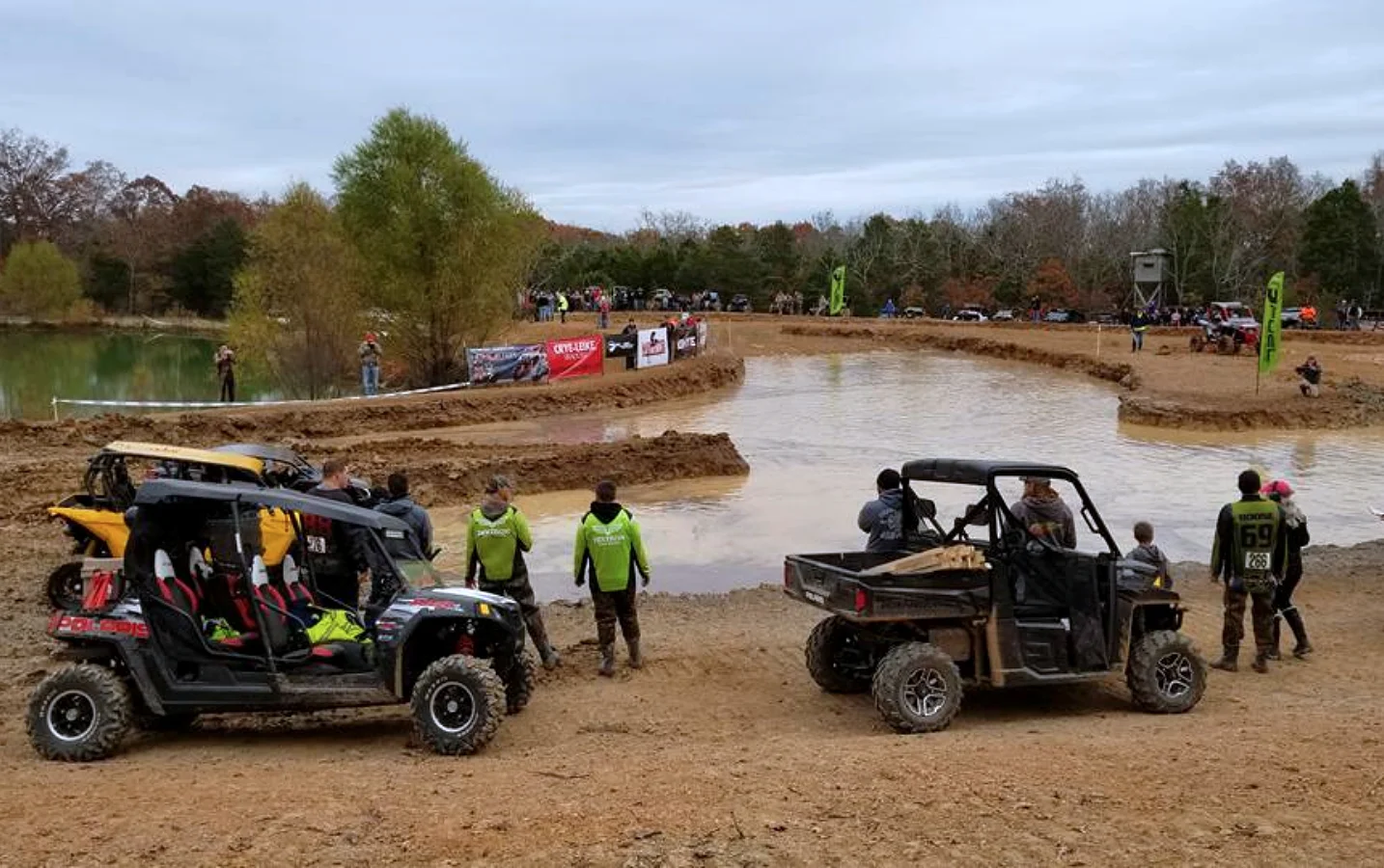Polaris side-by-sides or UTVs sitting next to a mud pit - SpecializedATV